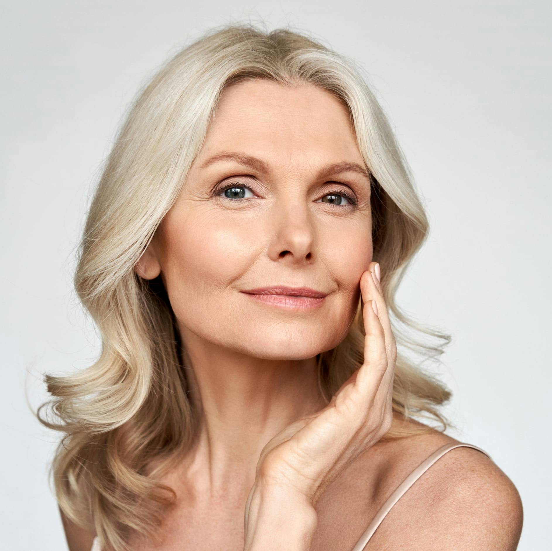 woman with her hand to her cheek