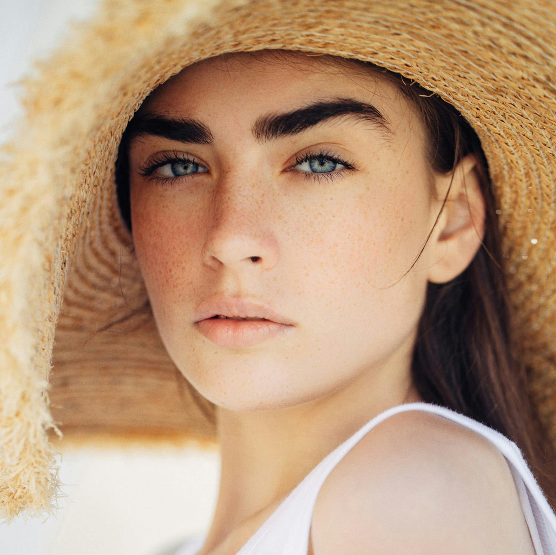 woman with a hat on and blue eyes