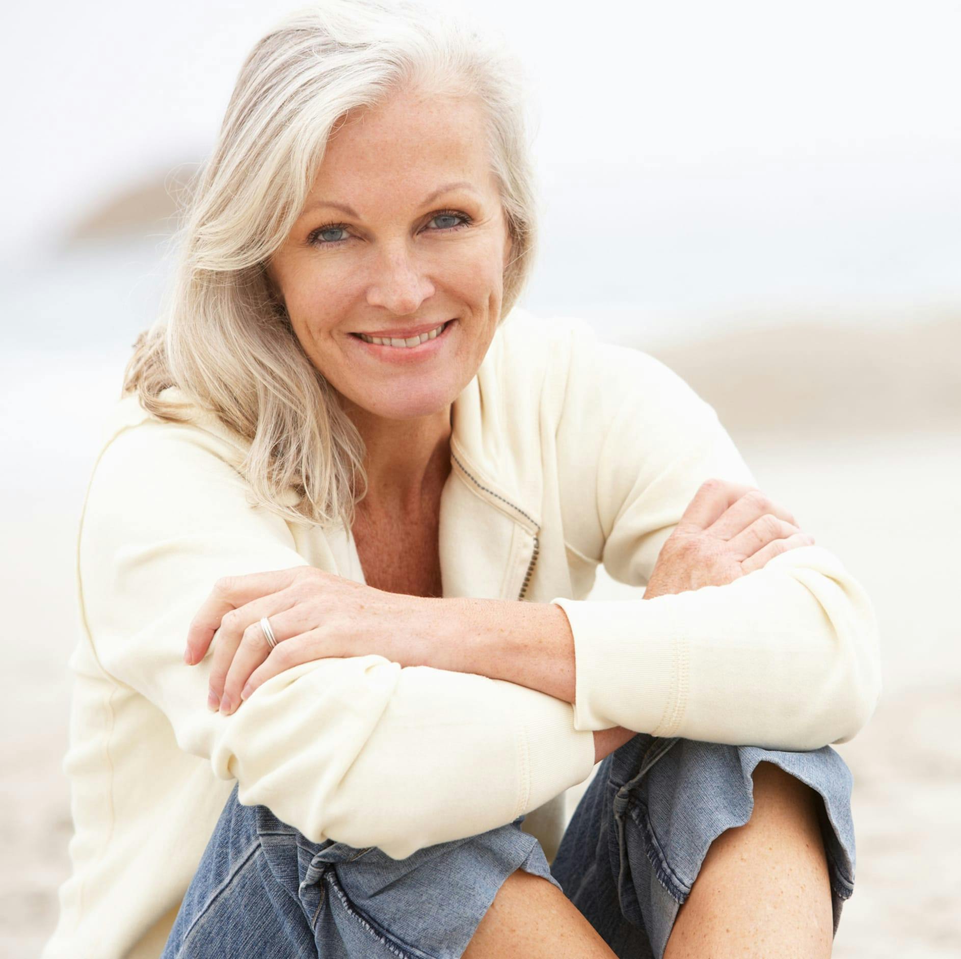 woman sitting smiling with her arms crossed