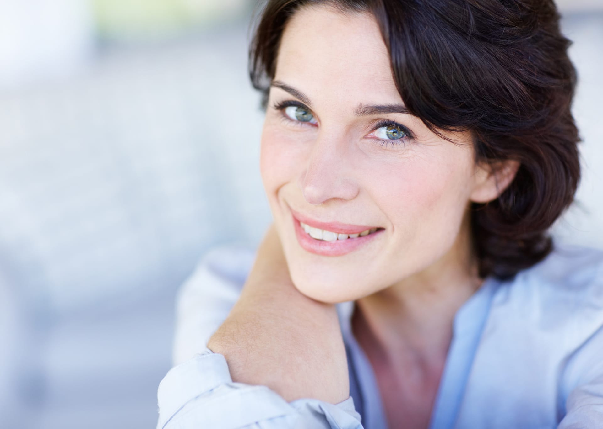 woman with a blue bouse on smiling