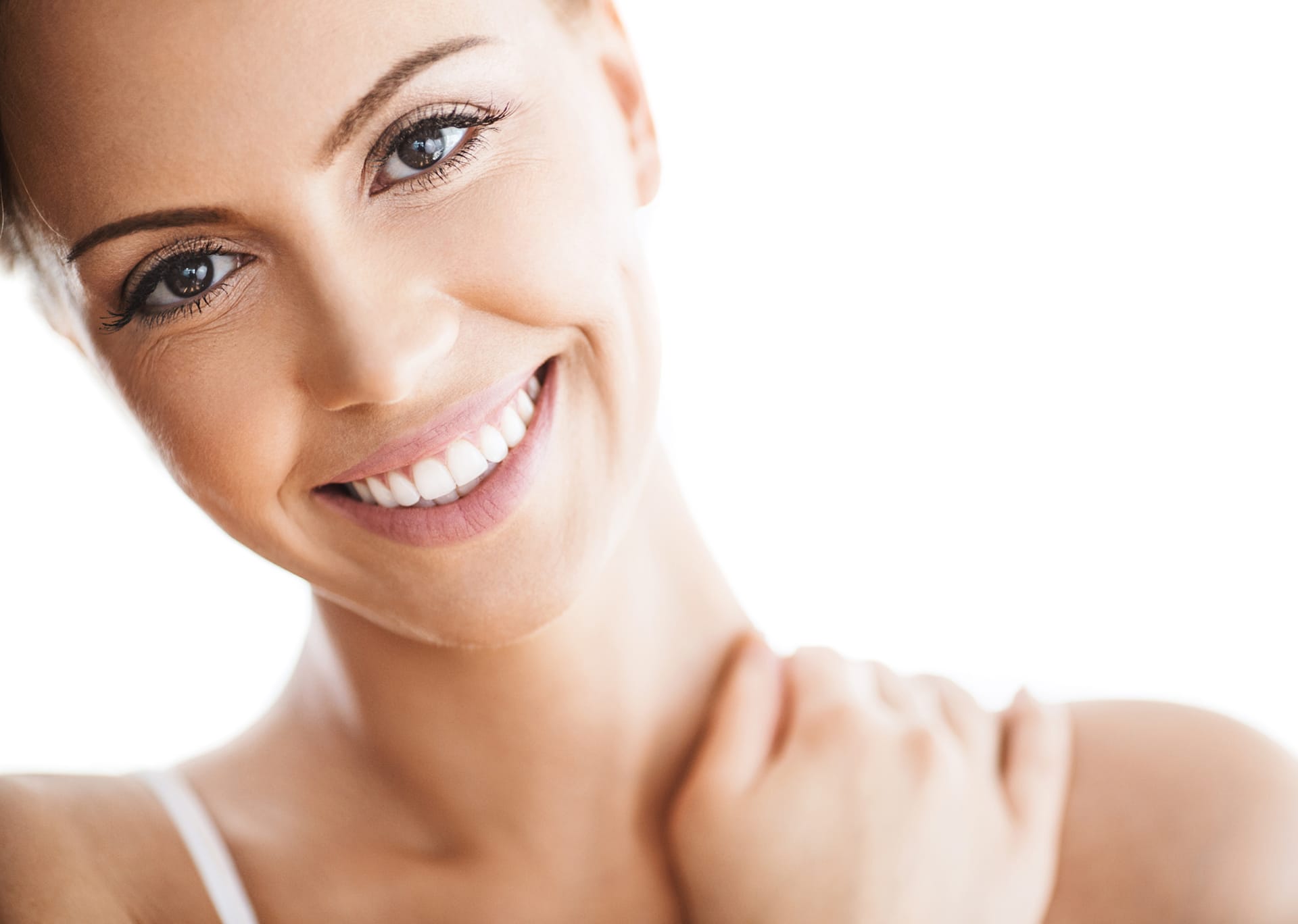 woman in a white tank top smiling 