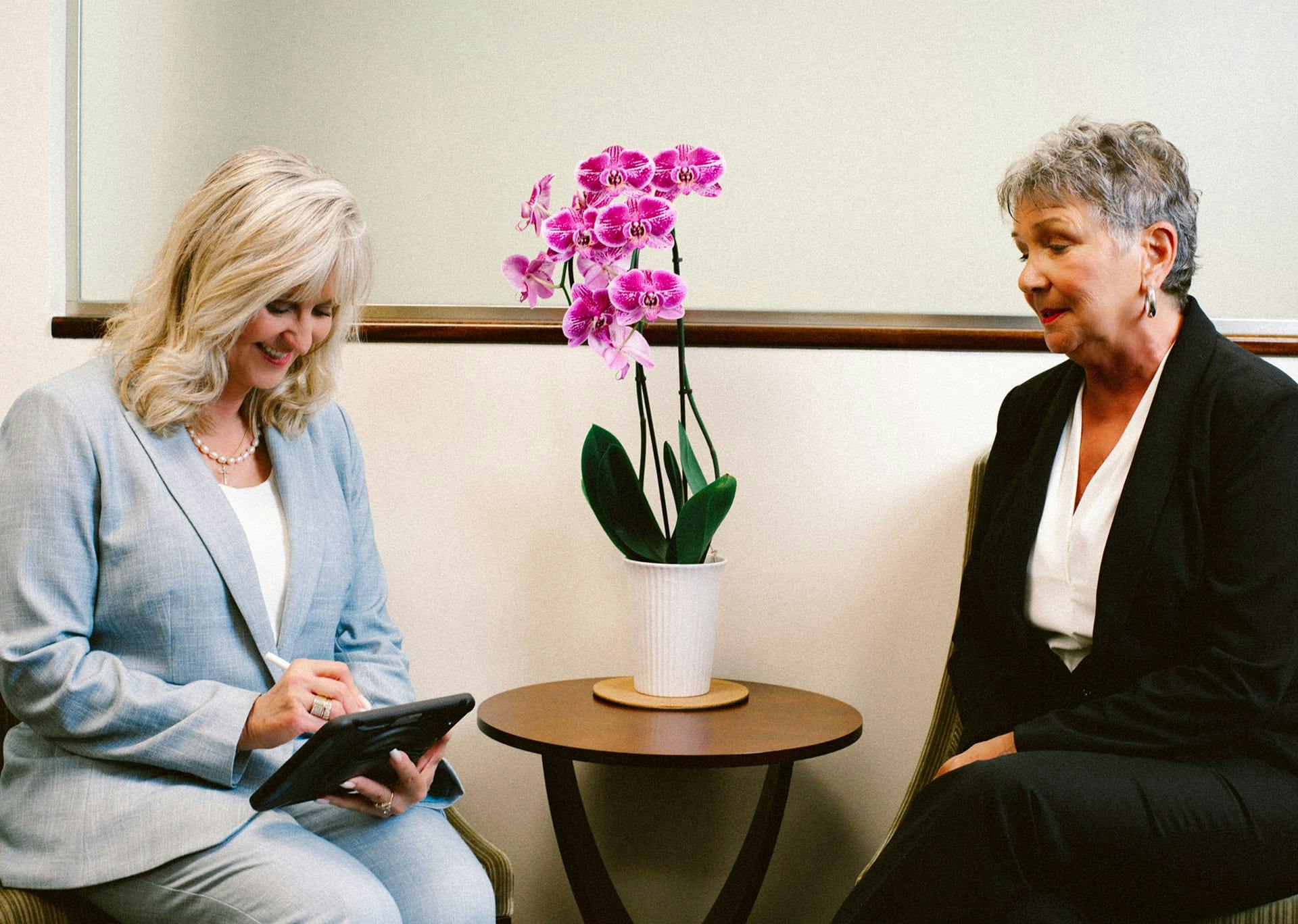 two women sitting with a table between them