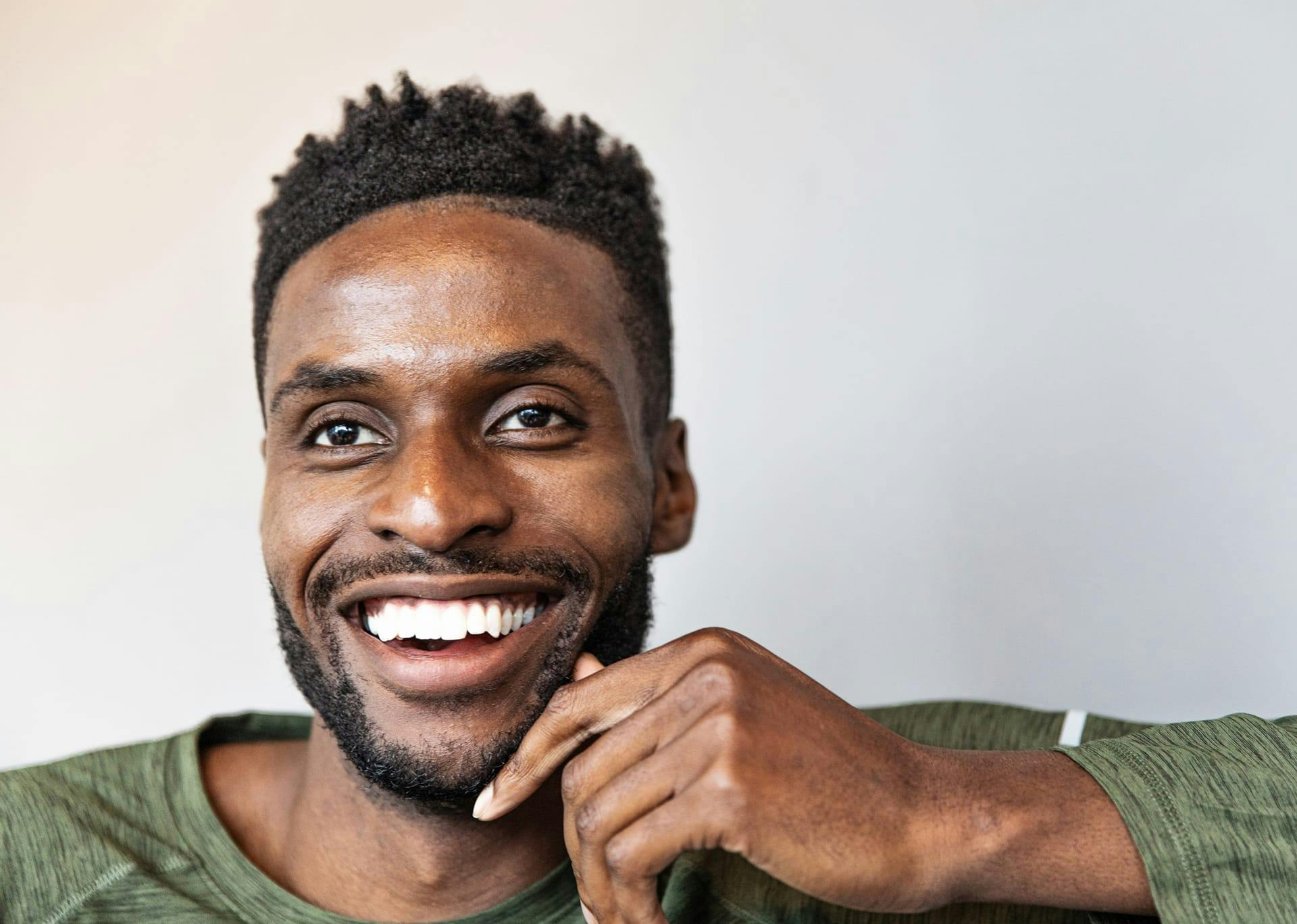 man smiling with brown eyes