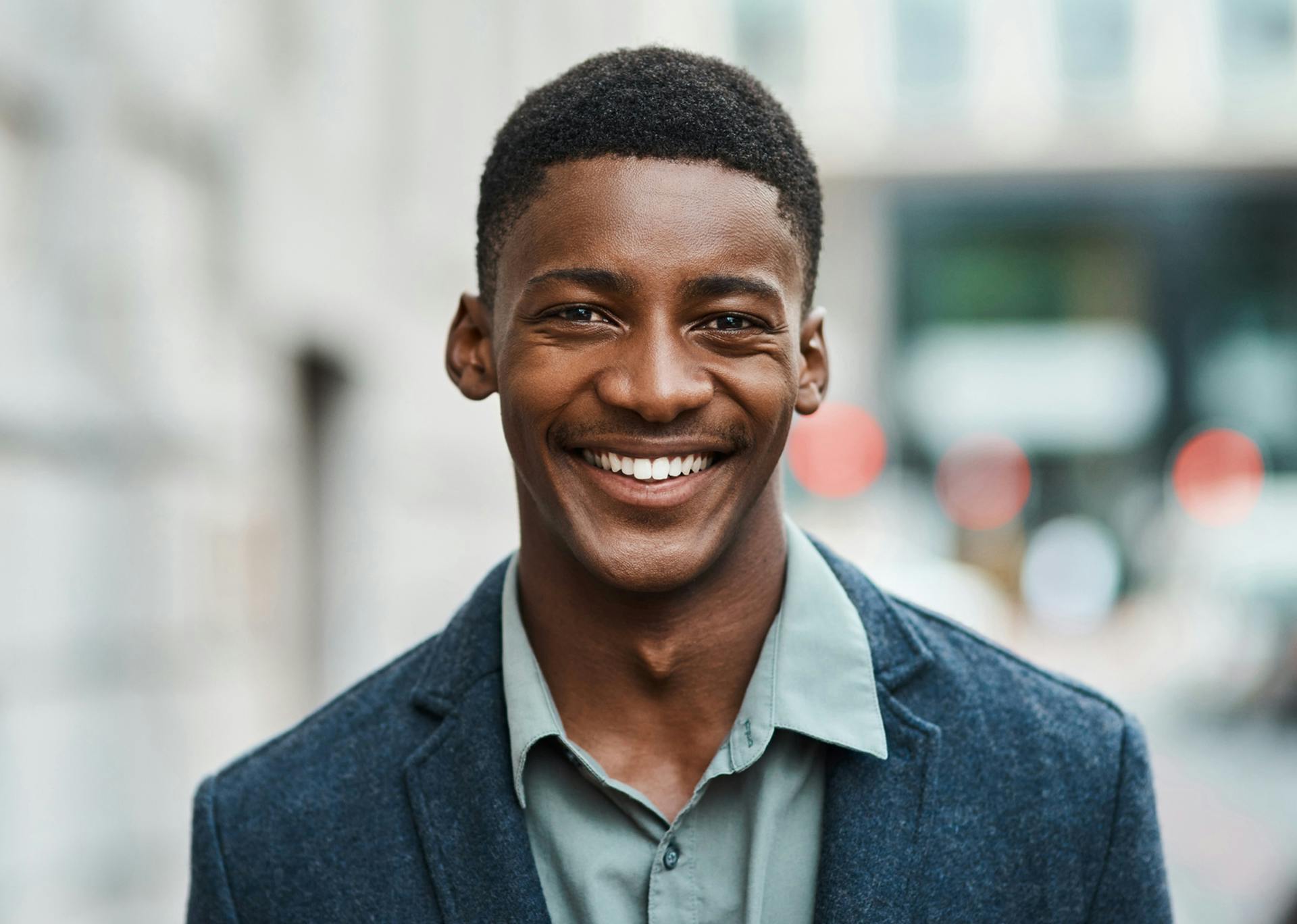 man in a blue blazer smiling