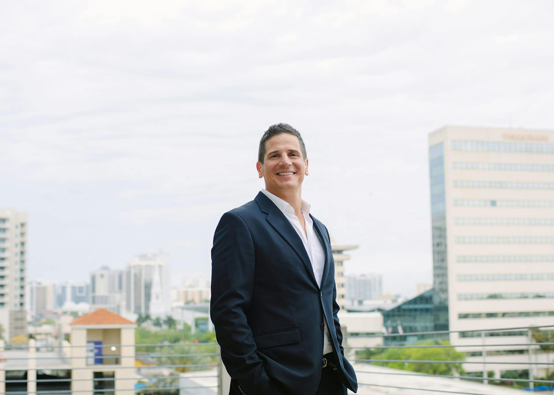 Dr. Joseph Greco, III with buildings in the background