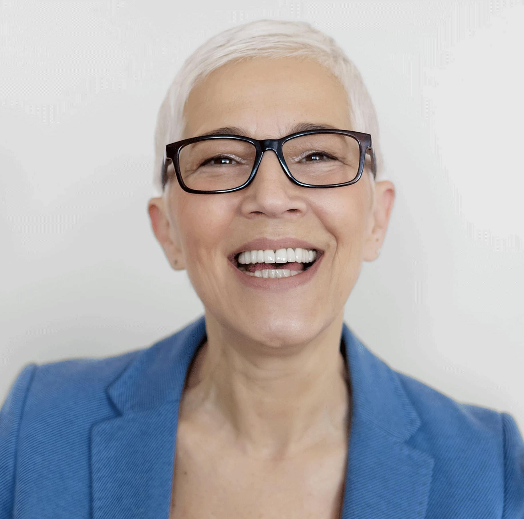 woman with short white hair and glasses