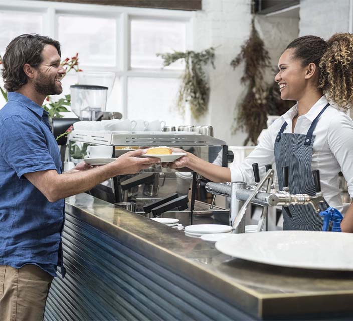 Hospitality worker serving food to customer