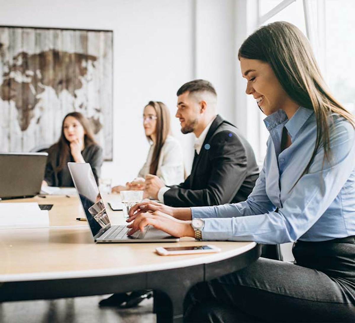 Female working on laptop in team meeting