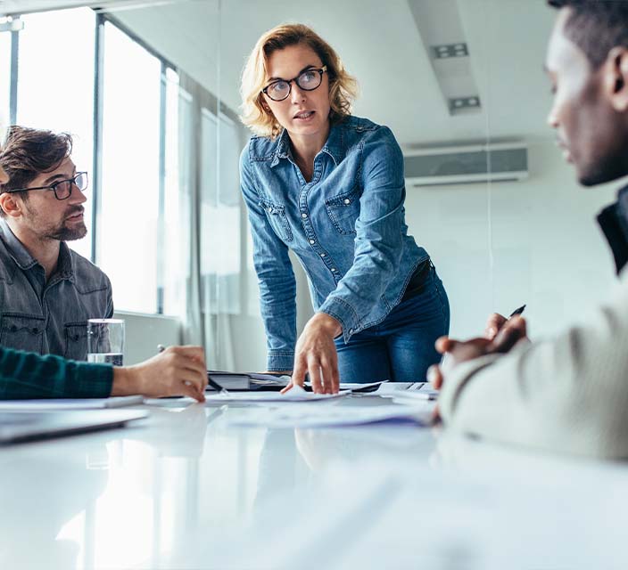 Female running a meeting with co workers