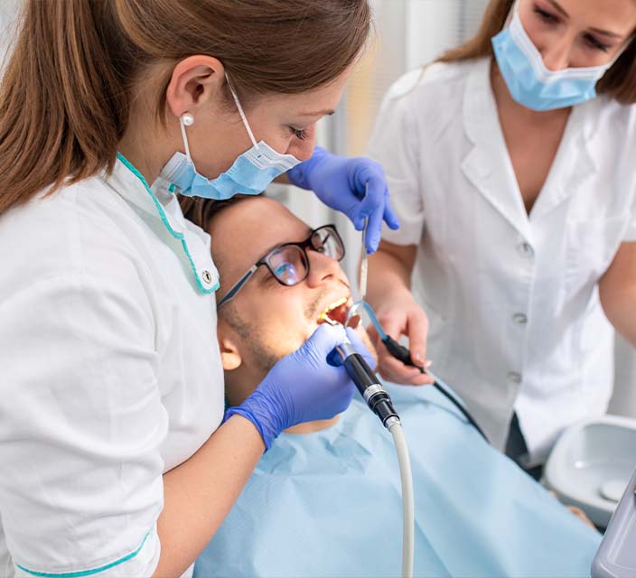 Dental Assistant helping Dentist with a procedure 