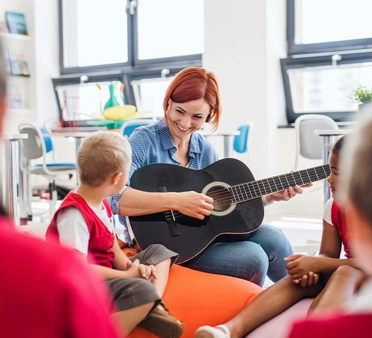 Childcare Assistant singing with children