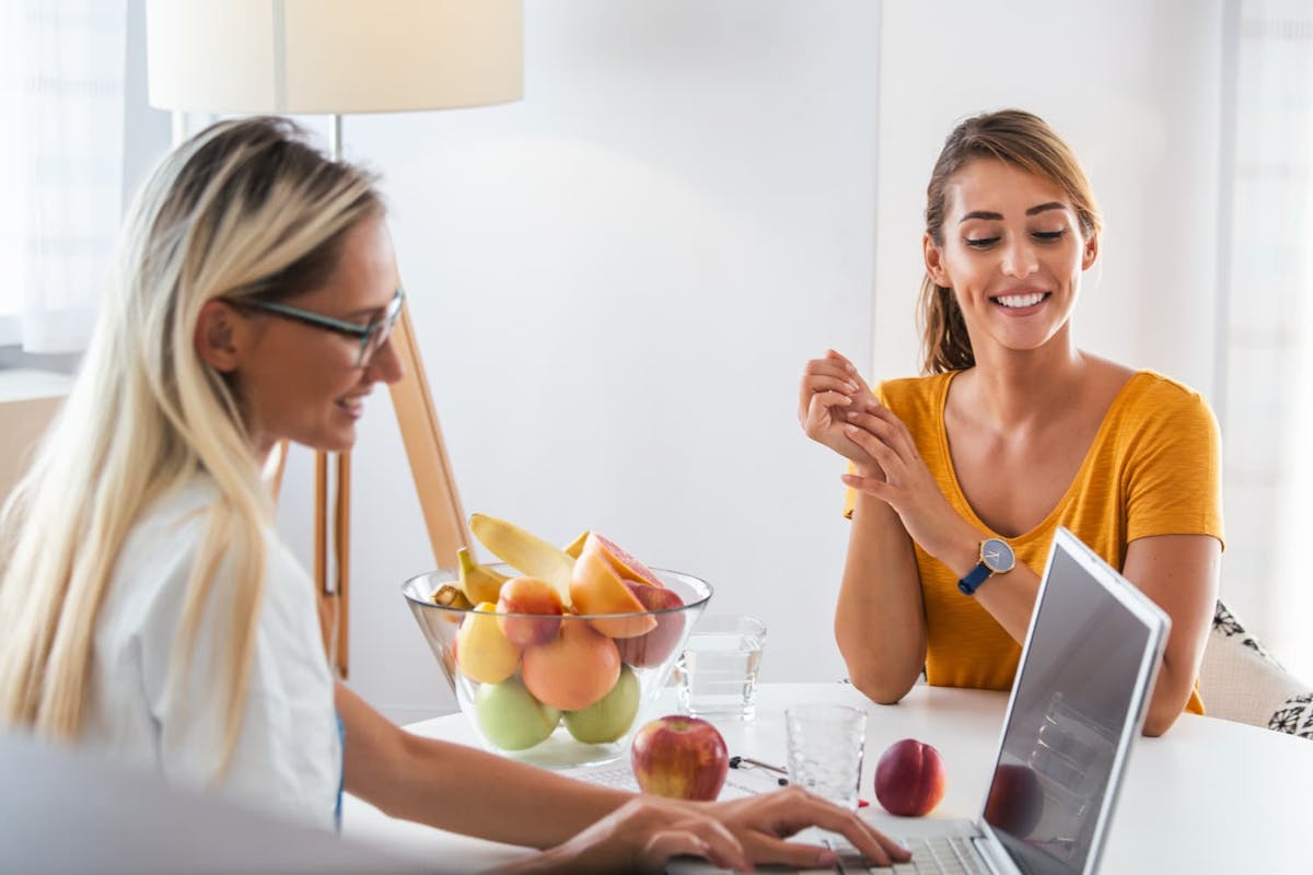 Nutritionist on Laptop with Female Patient - Foundation Education