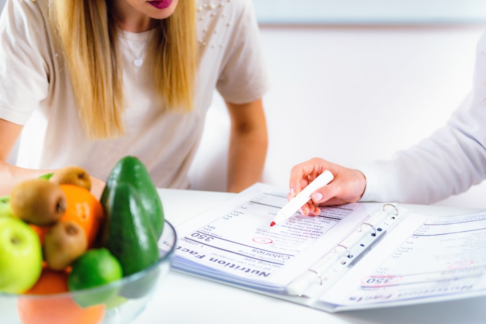 Nutritionist discussing a proposed meal plan with a patient