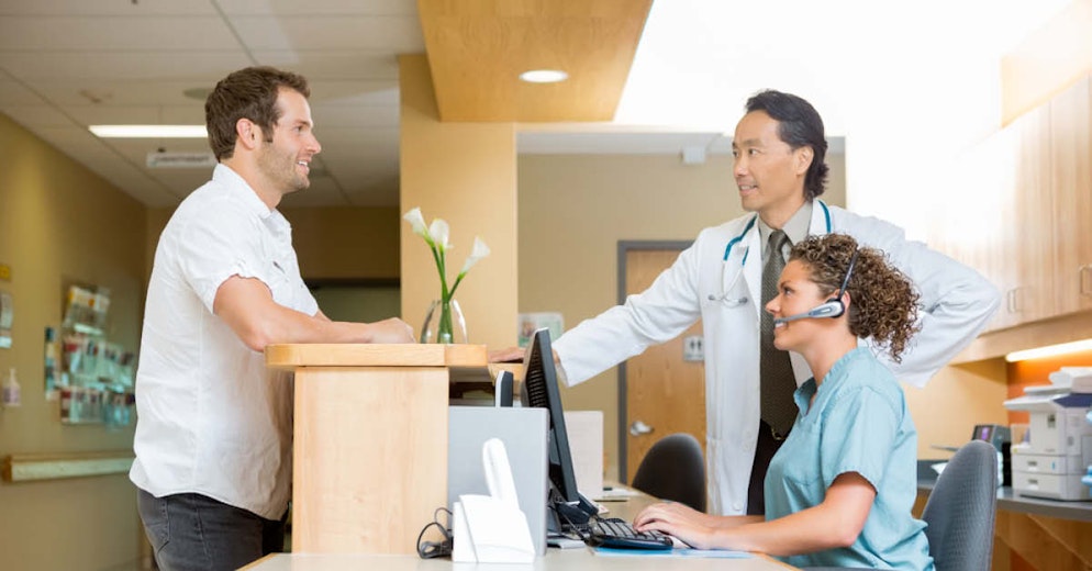 Medical Receptionist with Patient - Foundation Education
