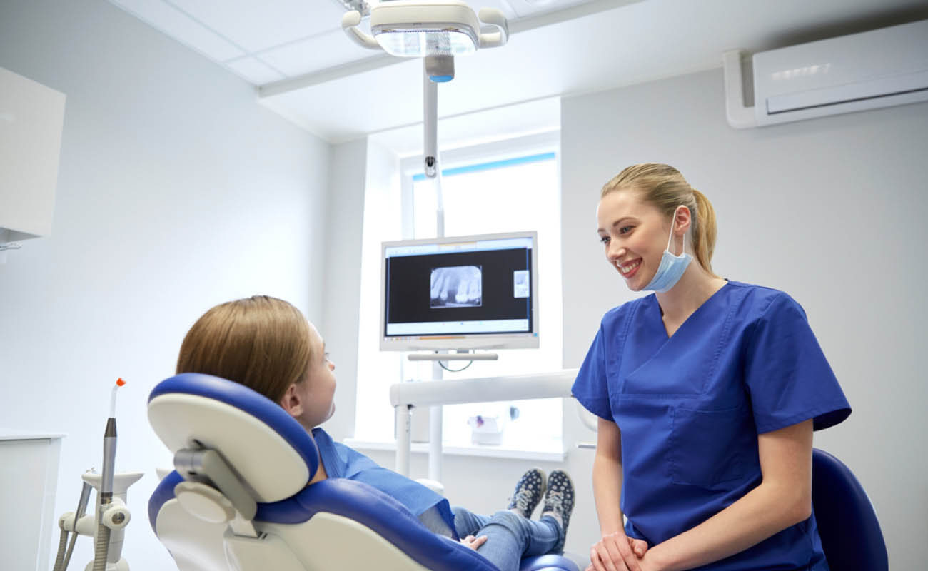 Dental assistant reassuring patient