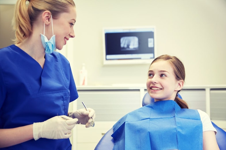 Dental Hygienist Talking to Patient - Foundation Education
