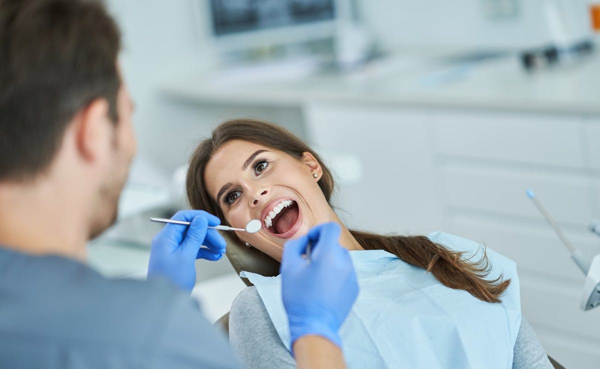 Dentist looking at woman's teeth