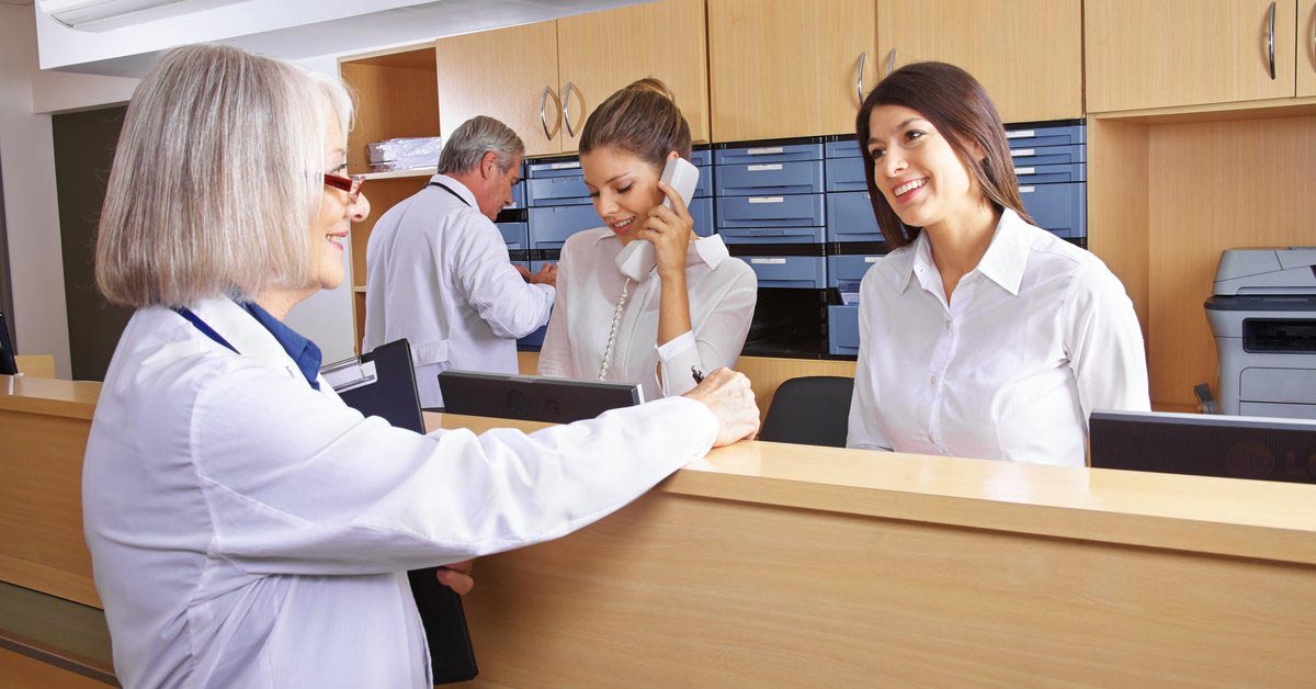 Several Medical Receptionists attending to patient matters