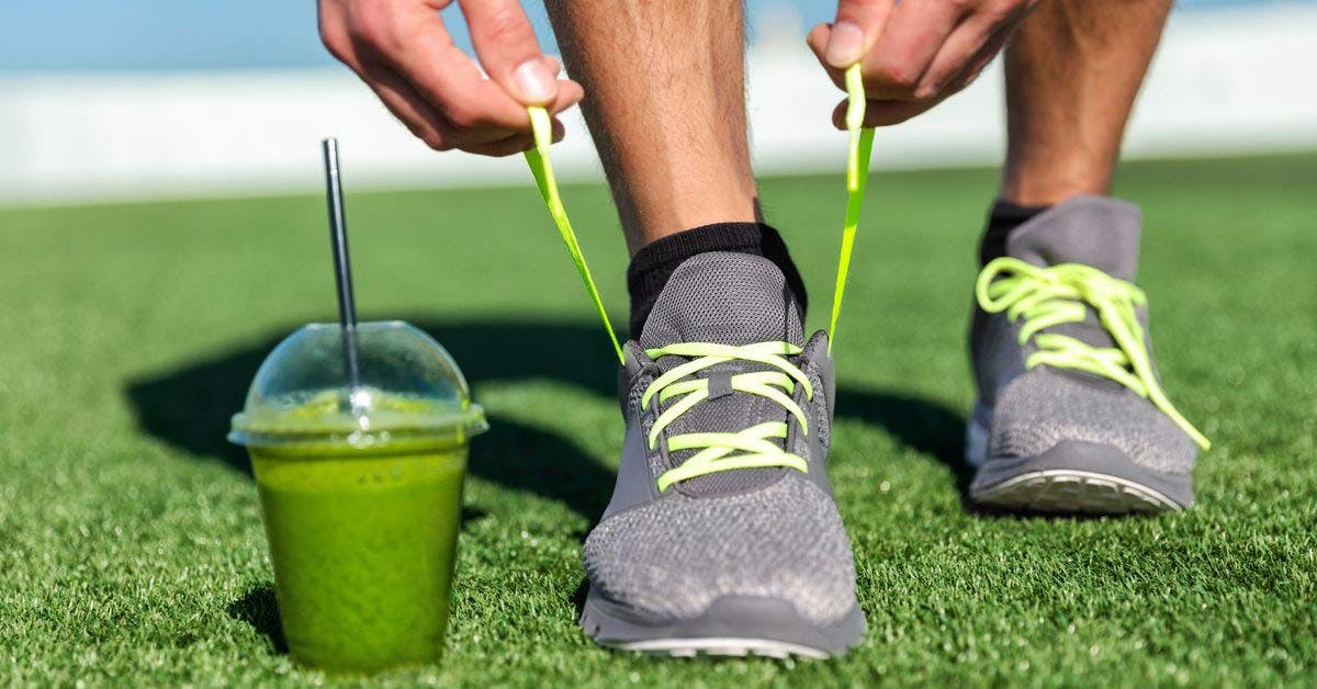 Runner tying shoelace with a healthy smoothie sent to his foot