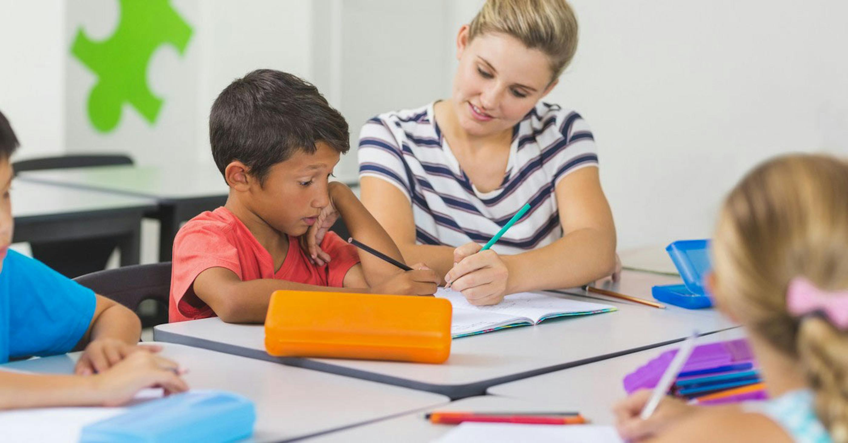Education assistant helping a preschooler 