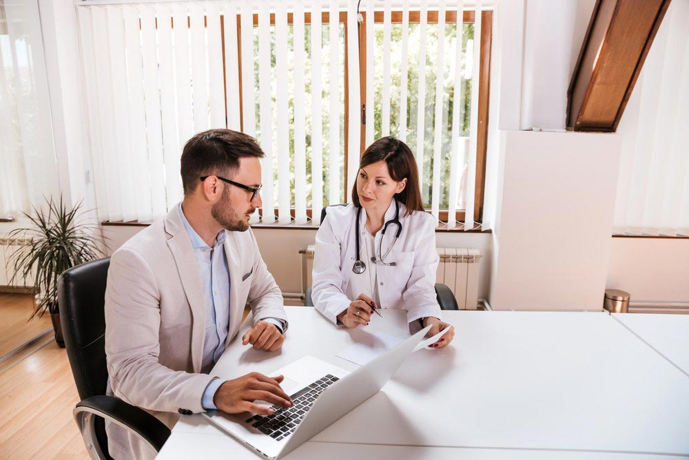 Hospital Administrator having an internal meeting with a doctor