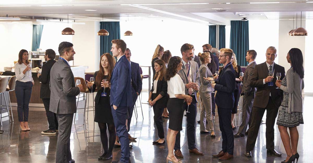 Employees taking part in a networking event to advance career