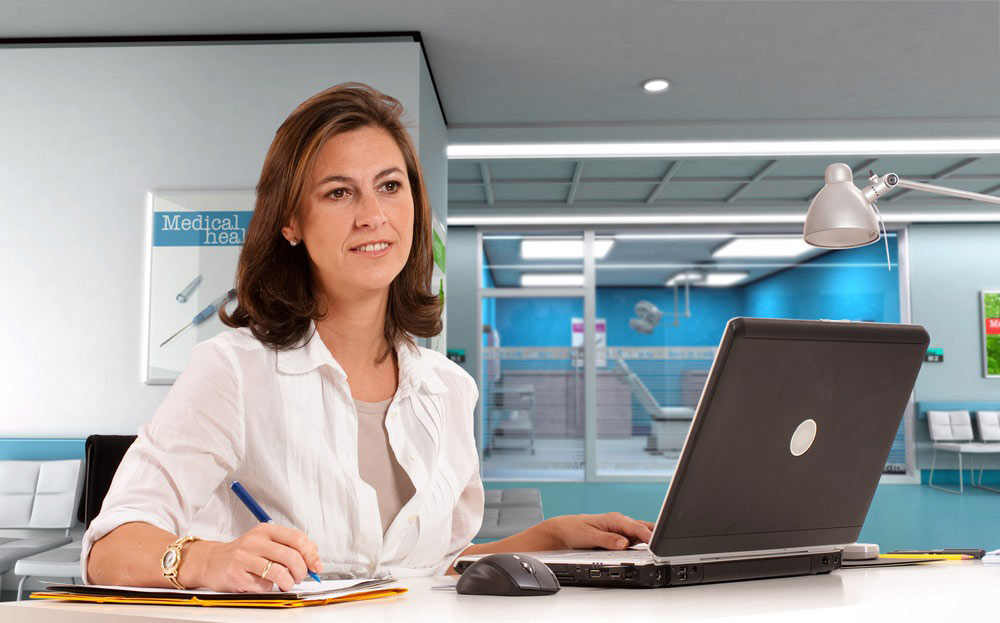 Hospital Administrator performing duties on a laptop