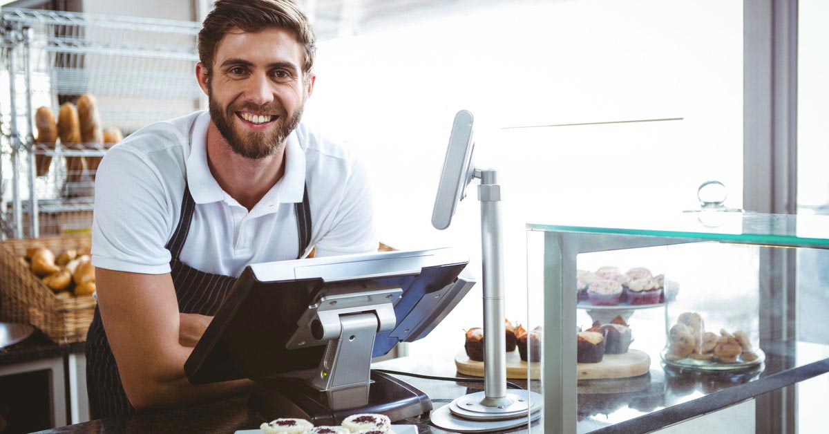 Male retail worker performing duties at his workplace