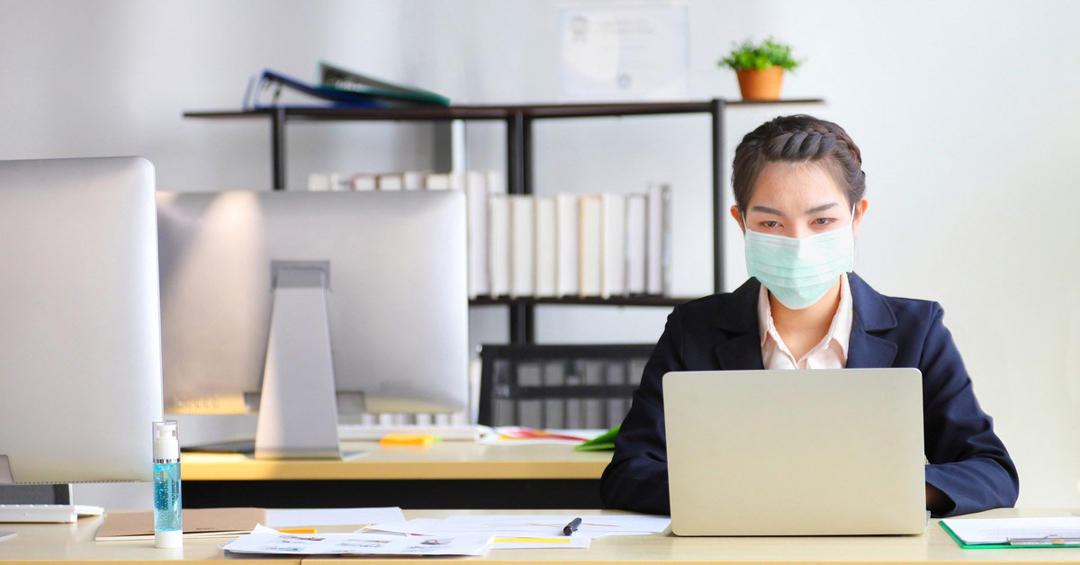 Staff member wearing a mask to pandemic proof workspace