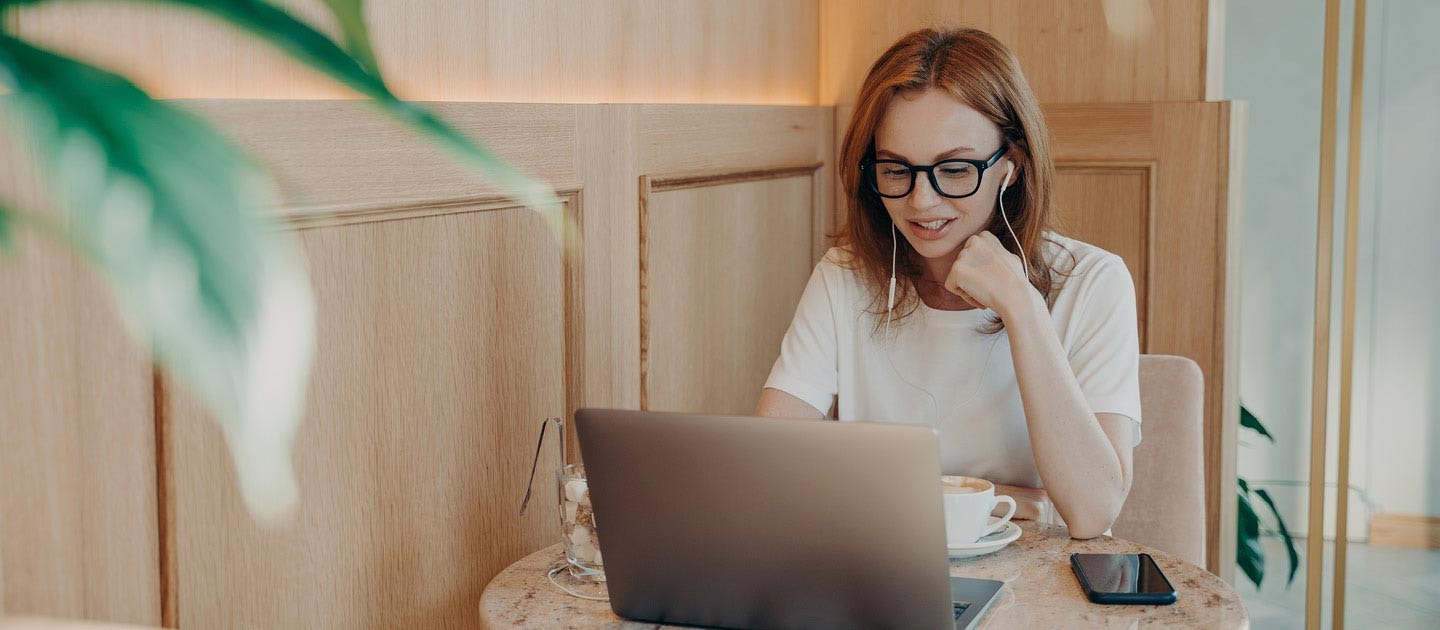 Girl on laptop in cafe 