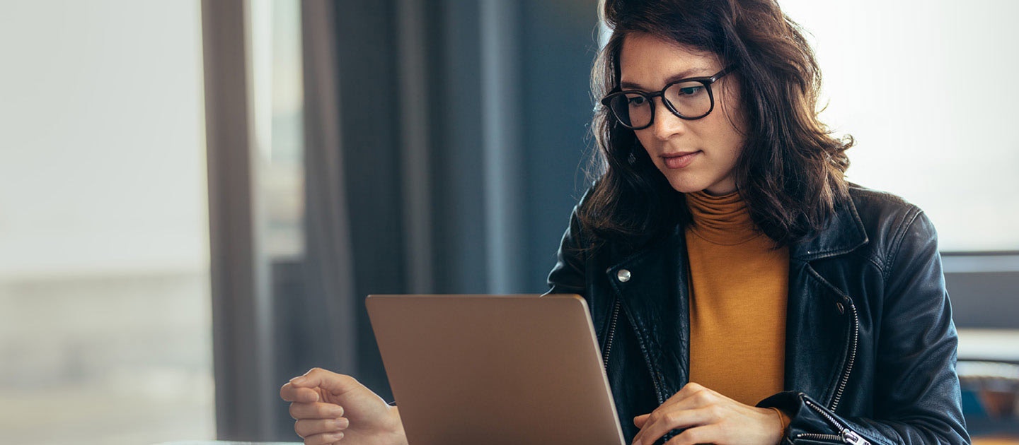 Woman with glasses using laptop