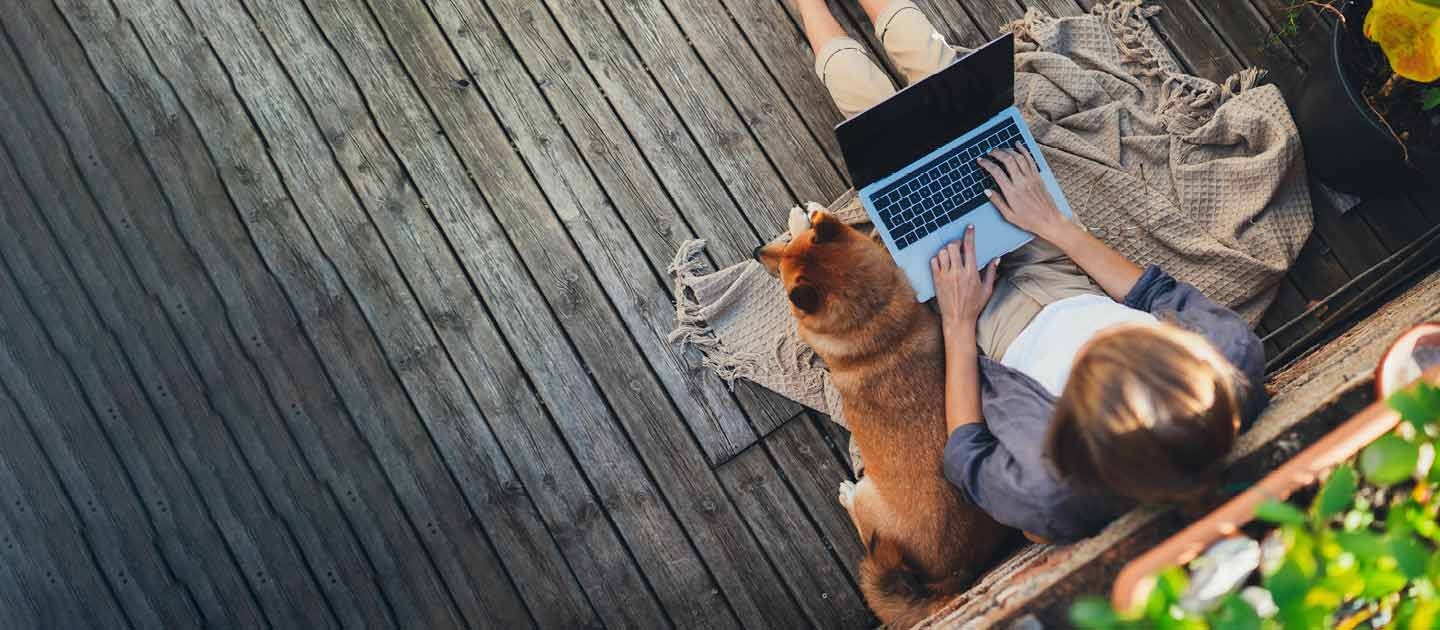 Woman studying outdoors with dog