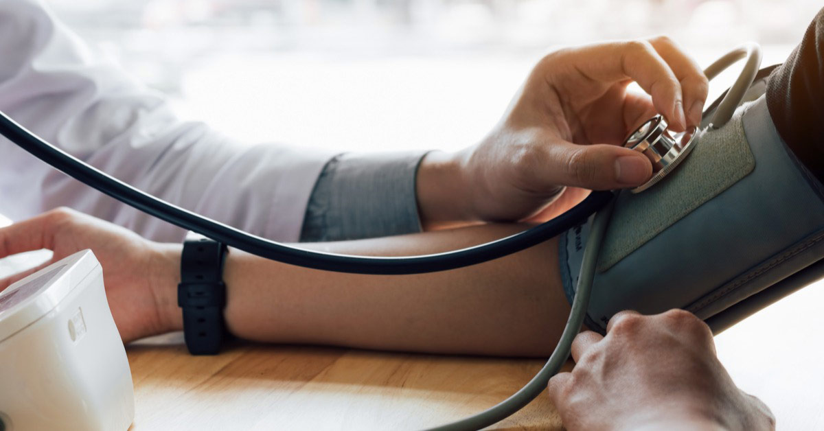 Allied health worker checking blood pressure and treating chronic disease