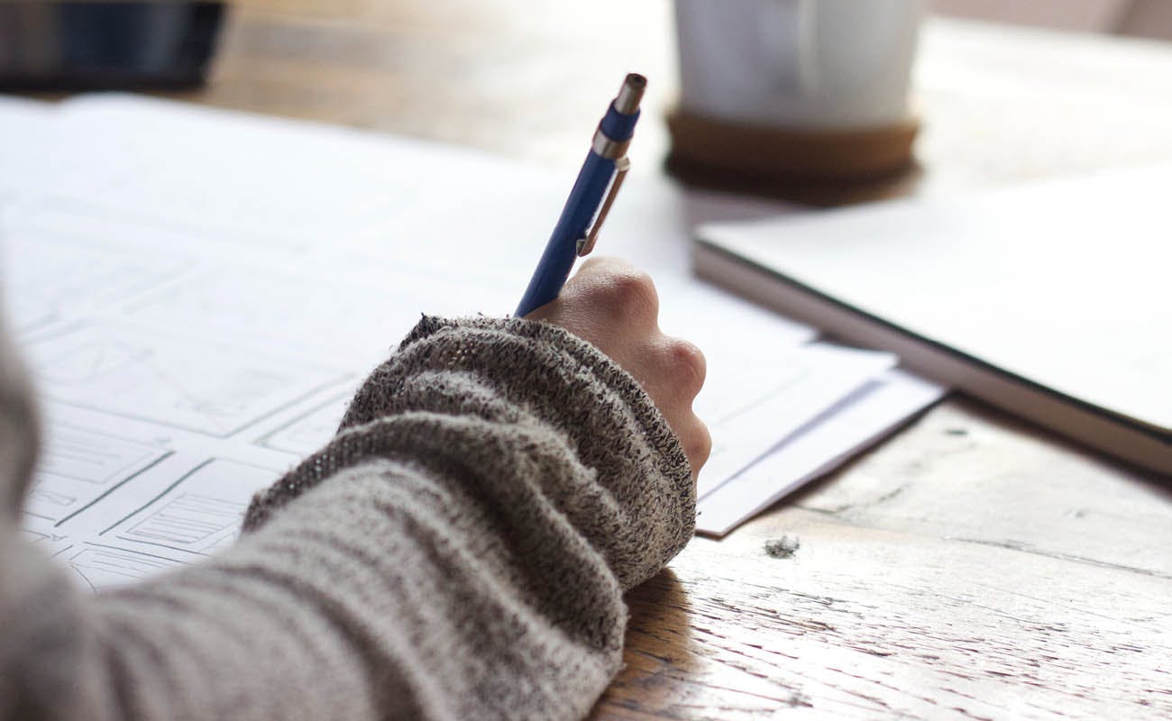 person writing on paper