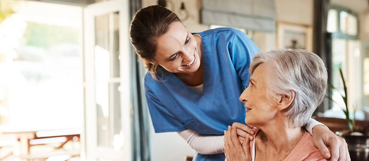 Woman assisting elderly lady