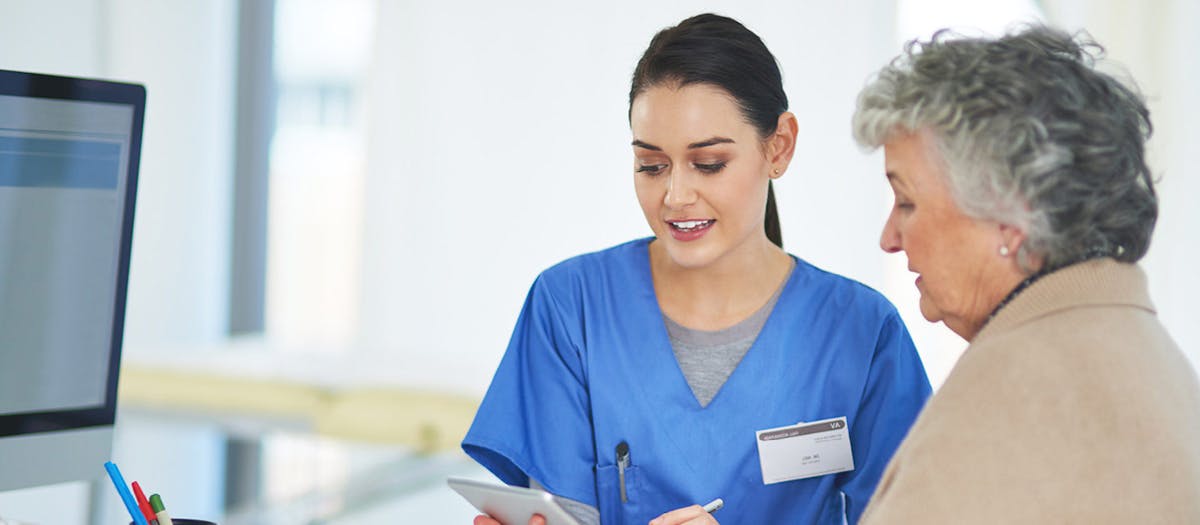 Receptionist assisting lady 