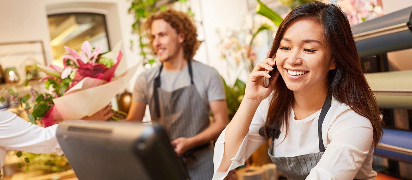 Retail worker on phone in shop