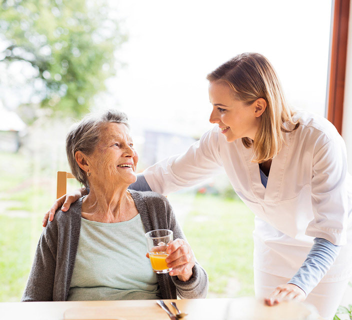 Woman helping elderly lady