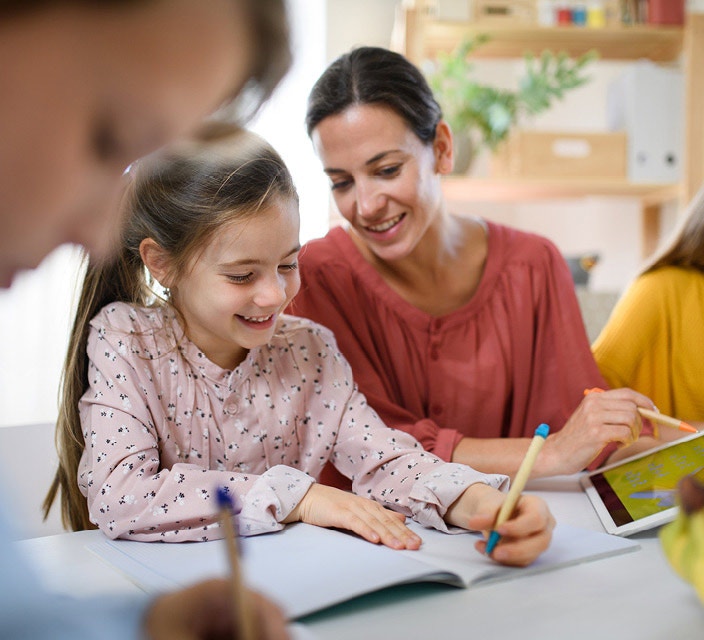 Teacher Aide helping student