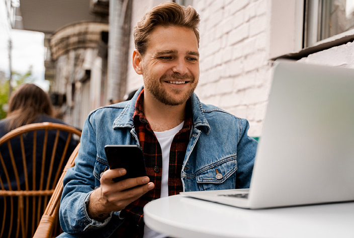 Man on laptop and phone