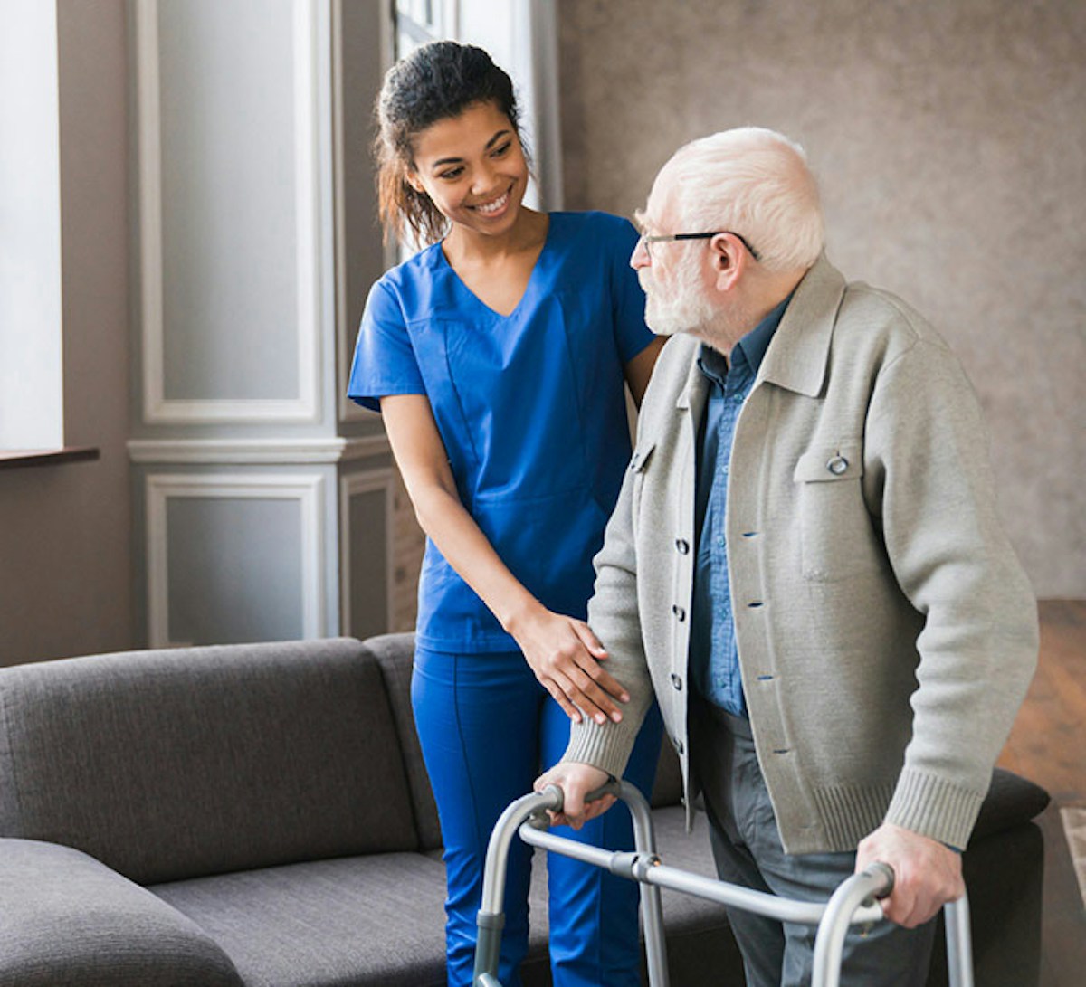 Woman helping an old man to walk