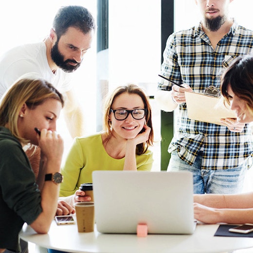 Group of business people looking at laptop