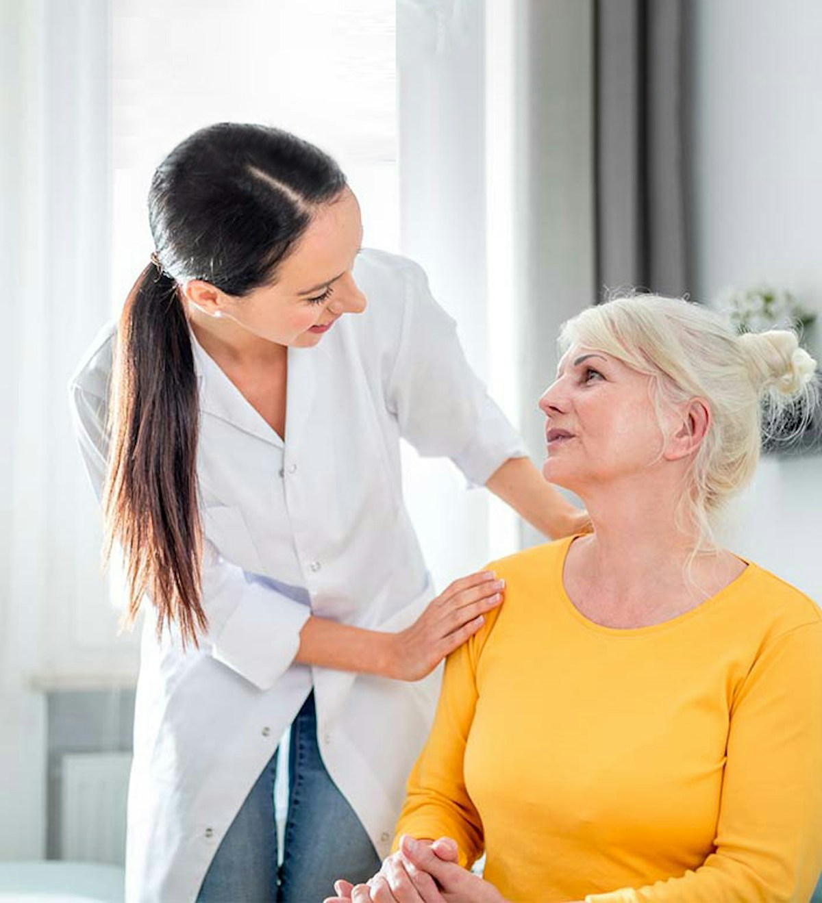 Woman helping elderly lady