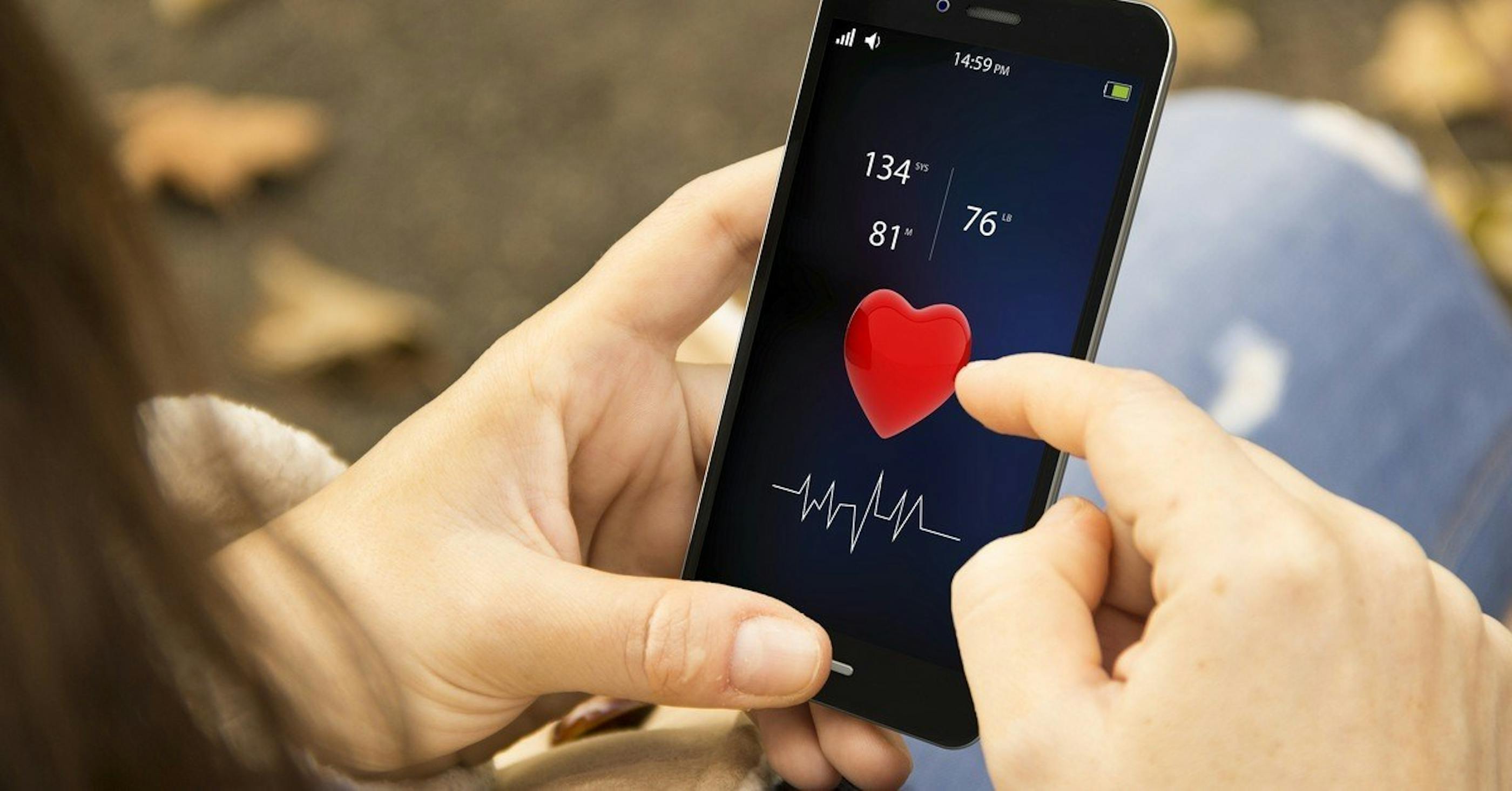 woman views heartrate on phone