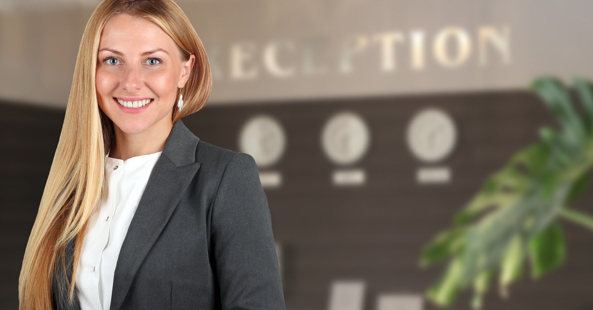 Female receptionist smiling at camera