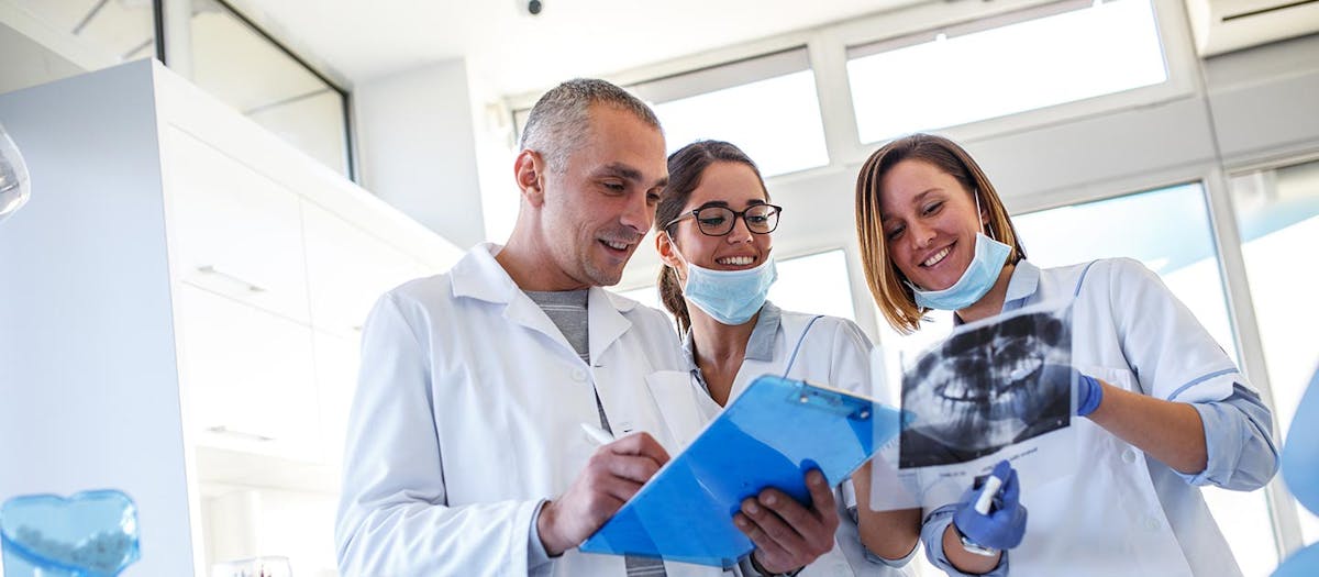 man and woman view dental x-ray