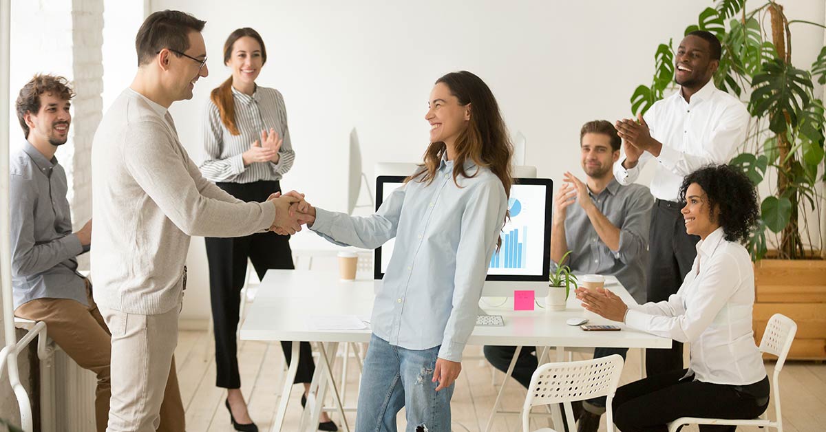 Manager shaking hand to staff member