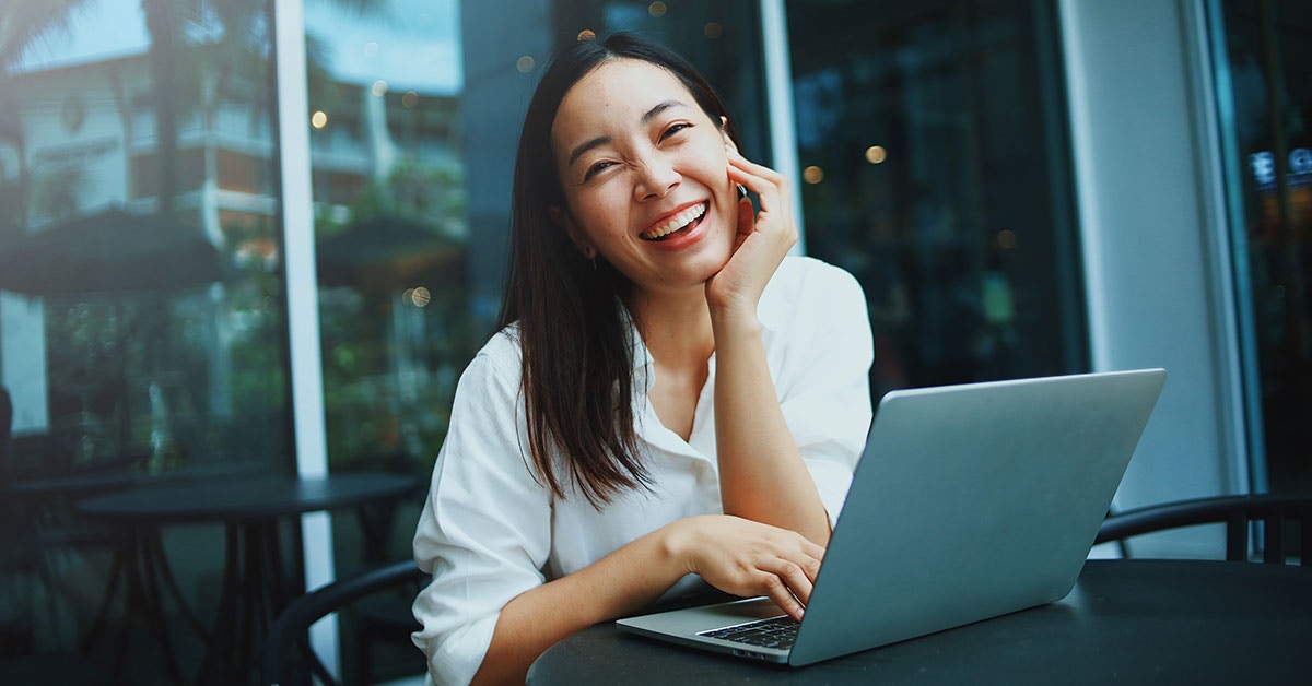 smiling woman using laptop