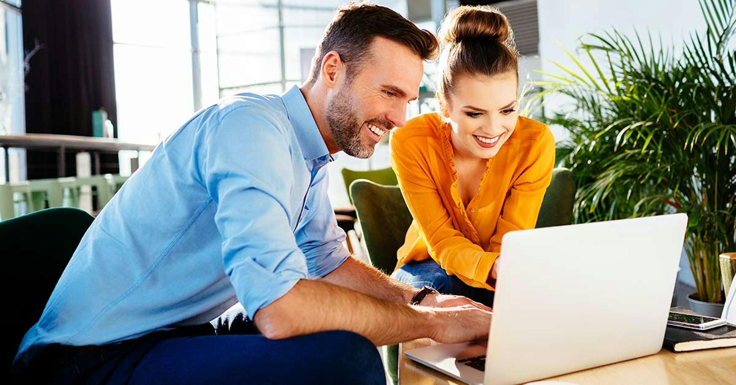 woman and men view laptop