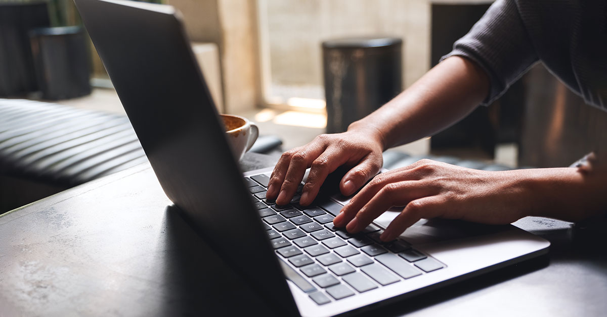 man types on laptop